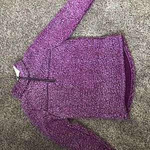 A purple, quarter zip, Sherpa sweatshirt.